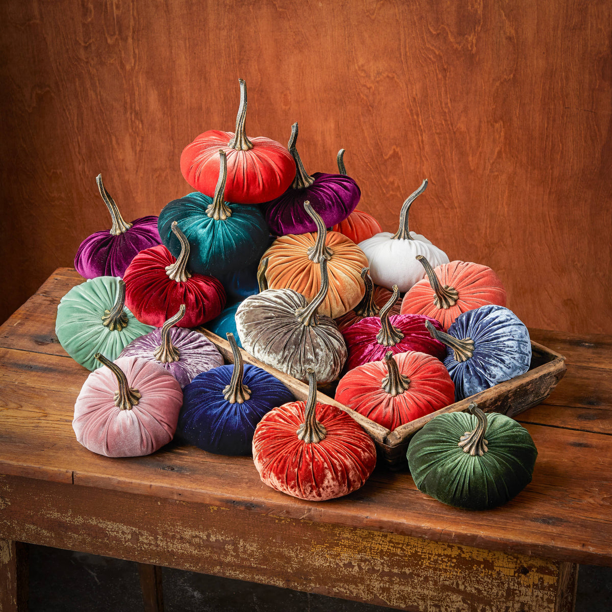 Pile of Handmade Velvet Pumpkins on Wooden table in wooden bowl with wooden background
