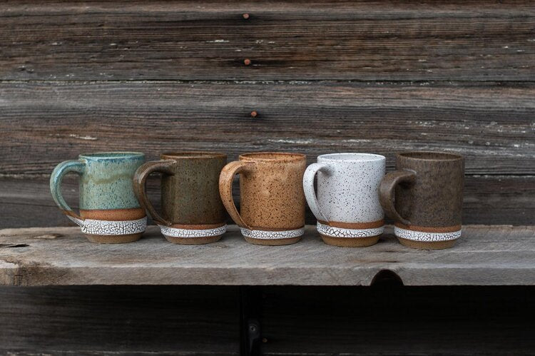 Lineup of 5 colors of Rainy Day Studio Mugs with Barnwood Background