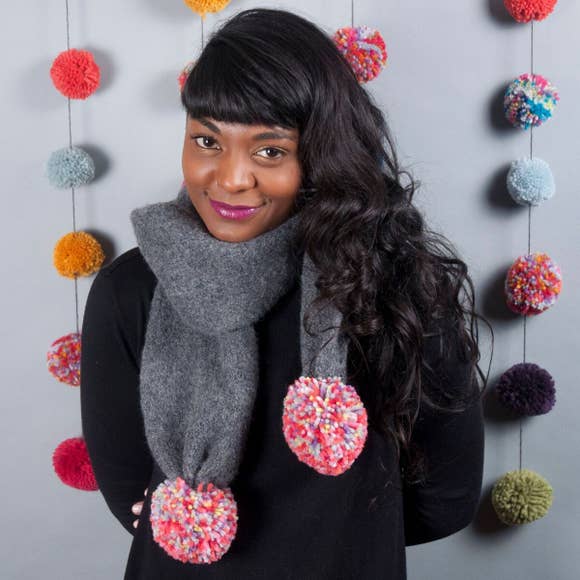 Model of a Dark Grey Scarf with Giant Multi-Colored Poms.