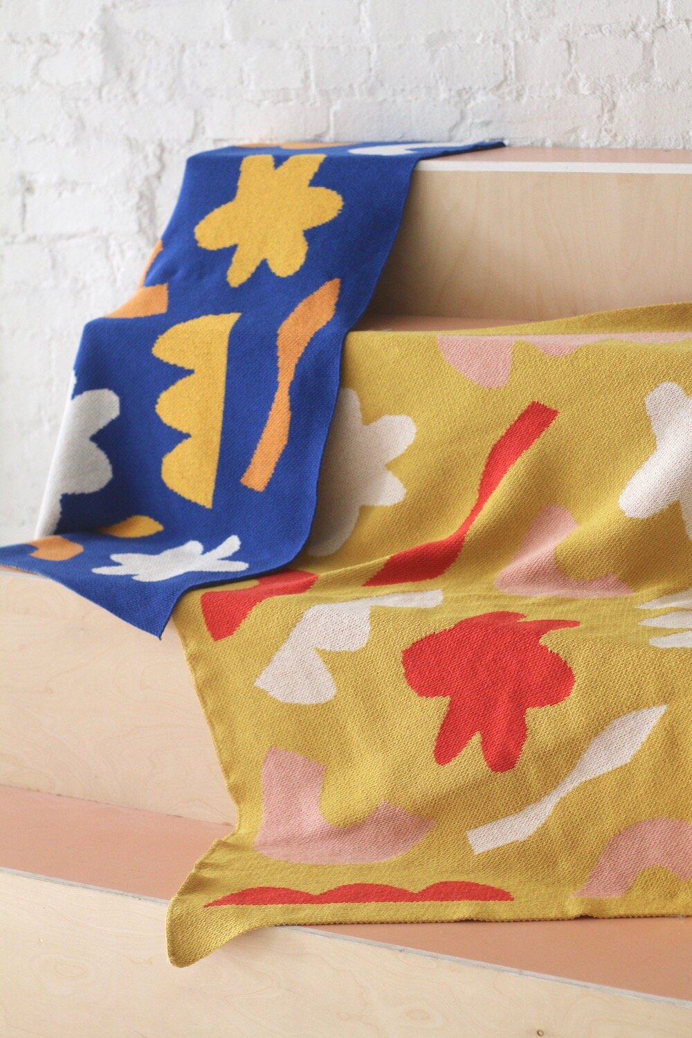 Blue and Yellow variations of the Shapes at Play geometric pattern throw