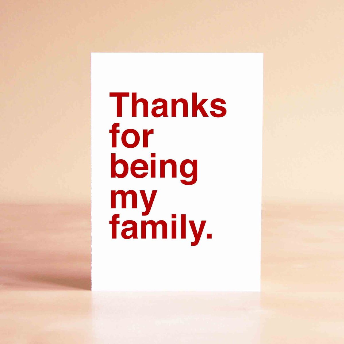 White card with red lettering reading "Thanks for being my family."