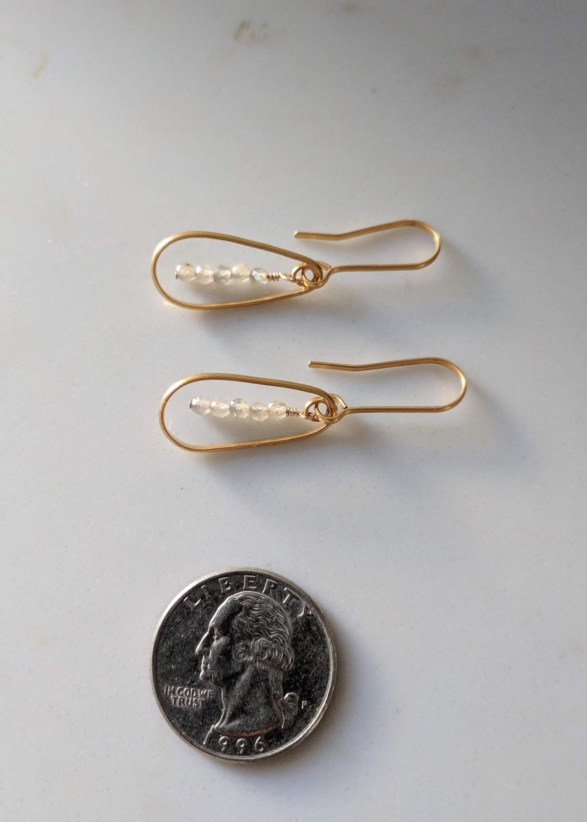 Earrings with a Quarter for scale