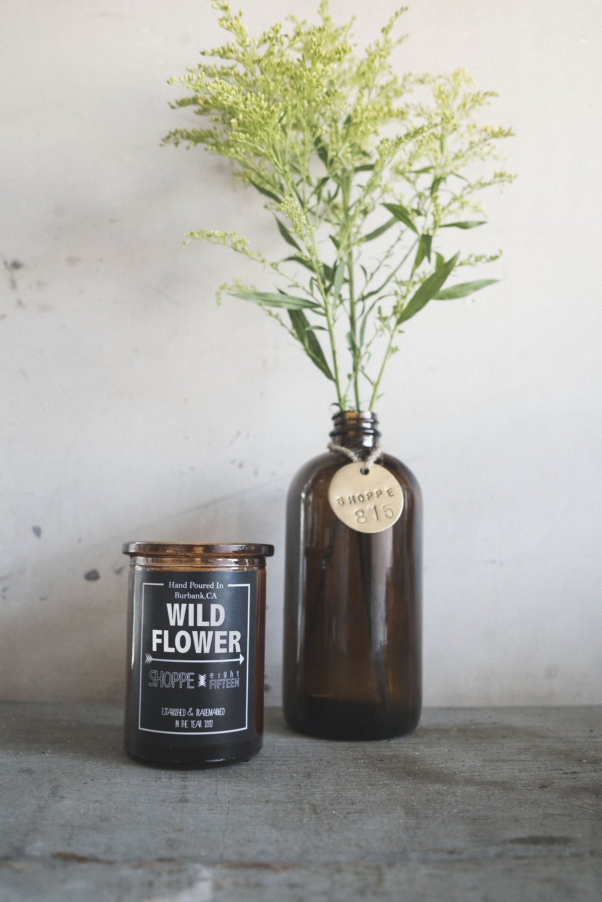 Wildflower Inspired Soy Candle in Amber Jar with Decorative Greenery and brass tag