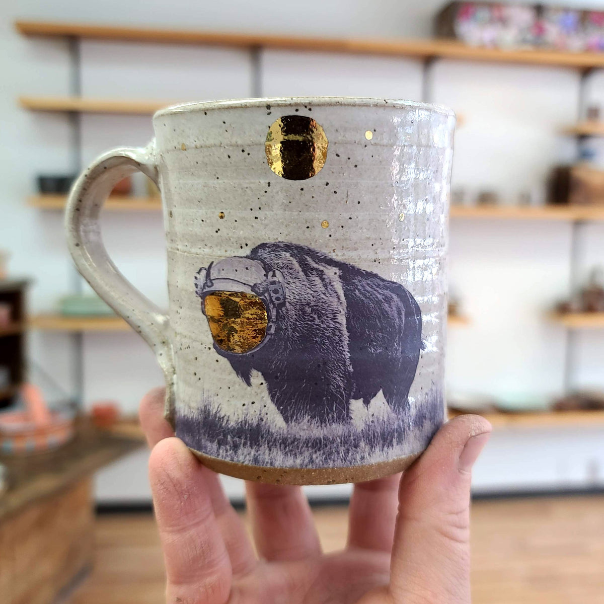 15oz Ceramic Mug with a bison in a space helmet with a gold shield