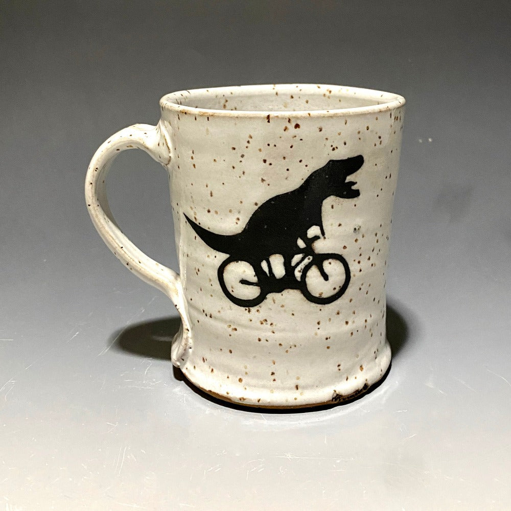 Black and White Handcrafted Ceramic Mug with a T-rex riding a bicycle
